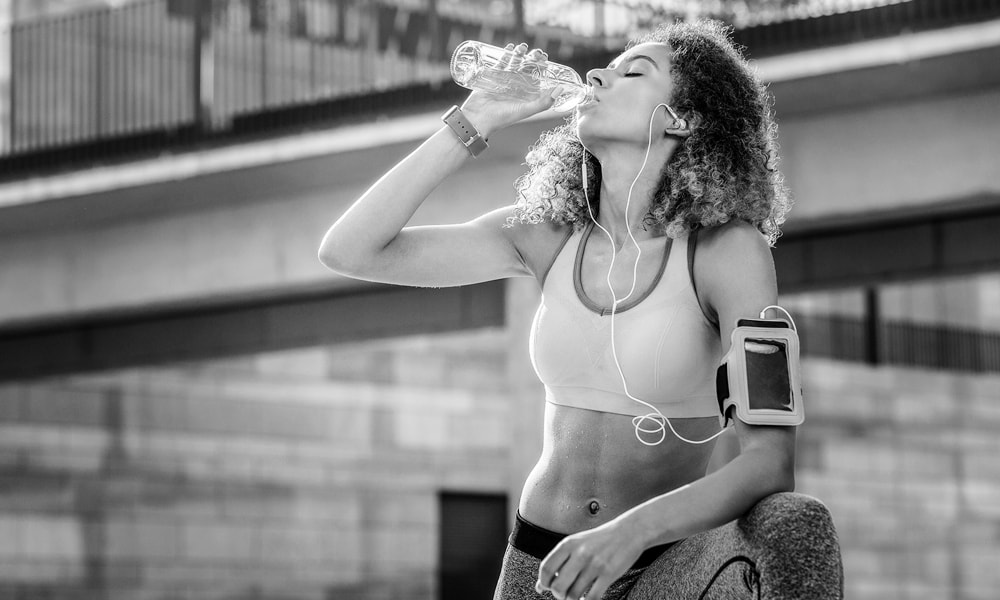 Runner drinking water