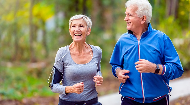 An senior couple jogging together in the park