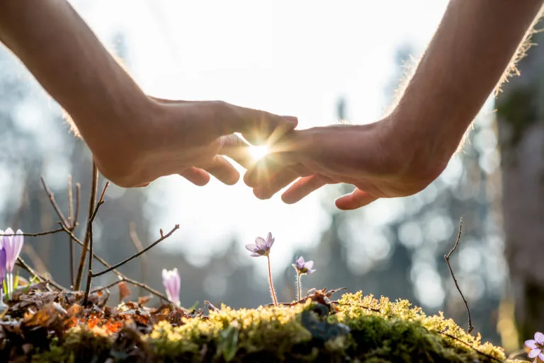 Sun peaking through hands