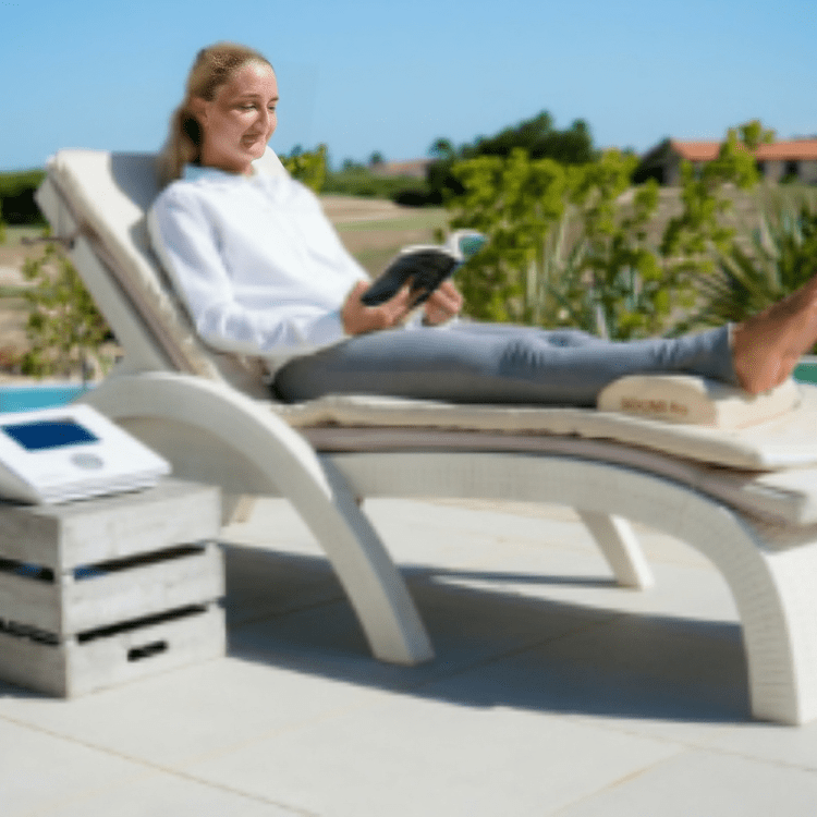 A woman sitting on a lounge chair