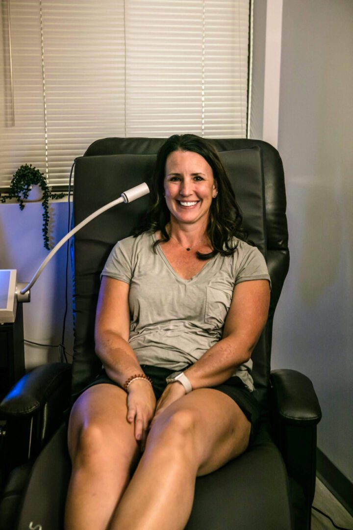 A woman sitting in a chair with her legs crossed.